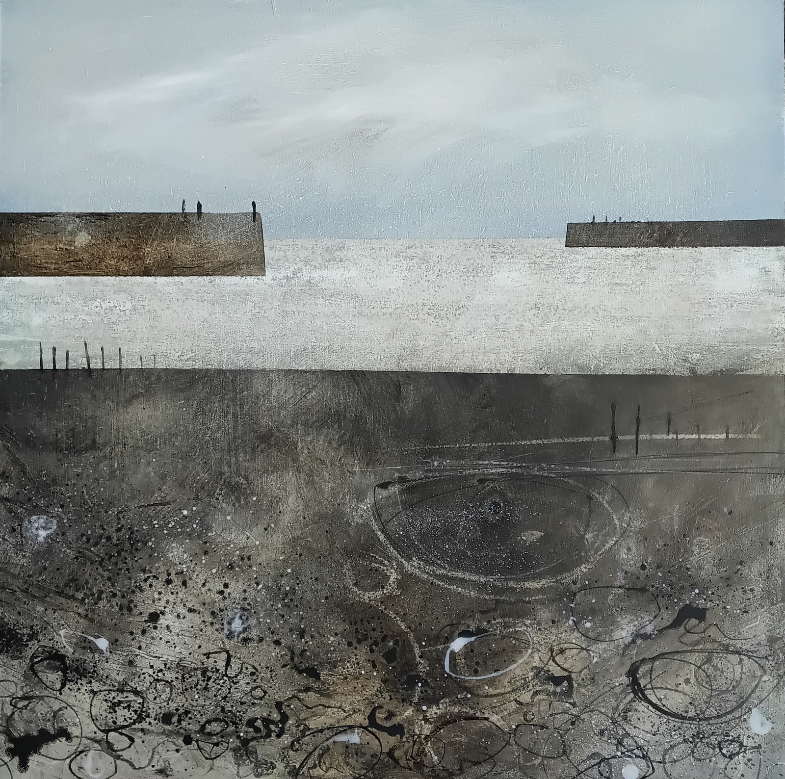 An abstract landscape painting featuring a pale gray sky, a wide light band, dark charcoal ground with circular and scribbled marks, and two low rectangular landforms with tiny human figures standing on them.