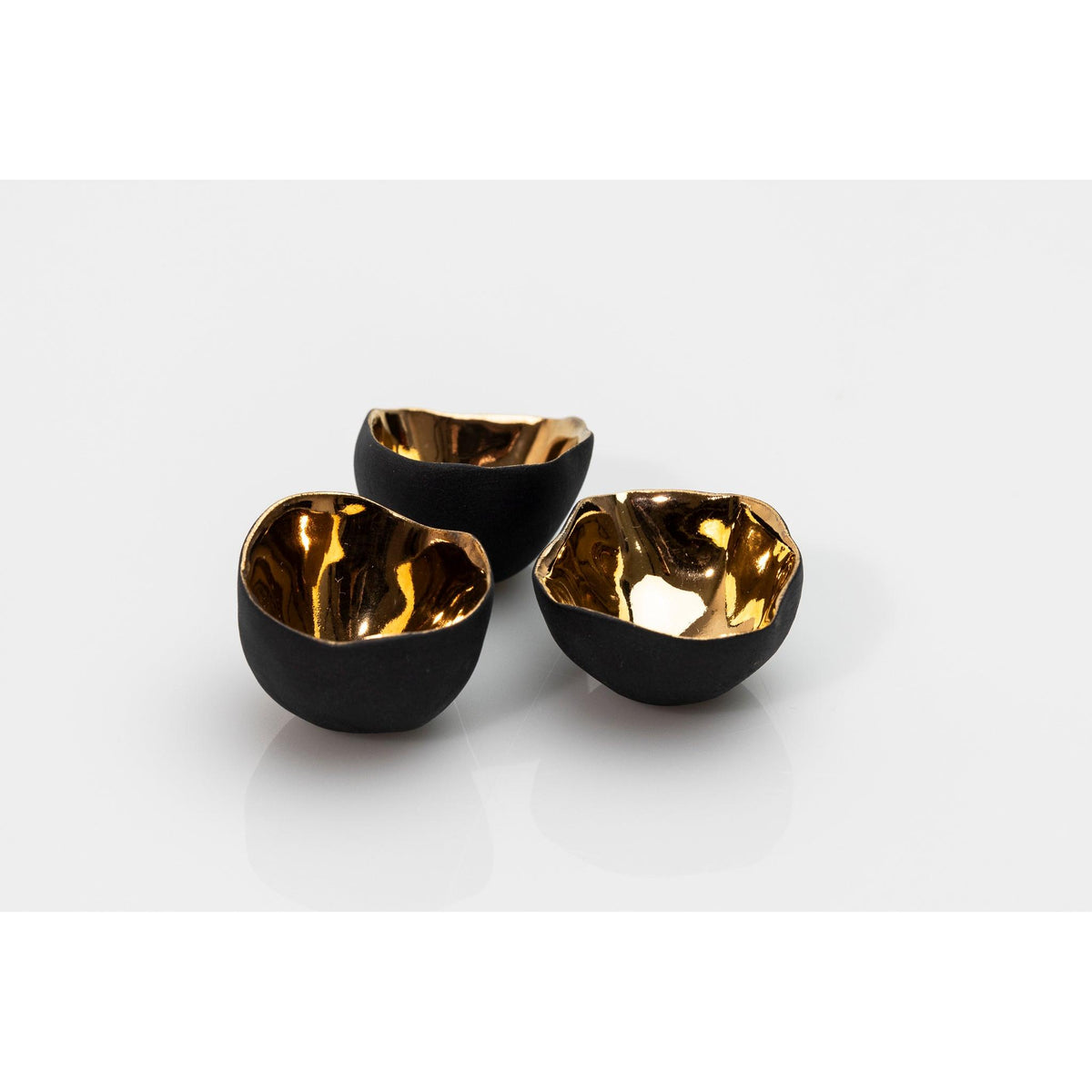 PL04 Trio of Bowls, black porcelain and gold lustre by Penny Little. Available at Padstow Gallery, Cornwall