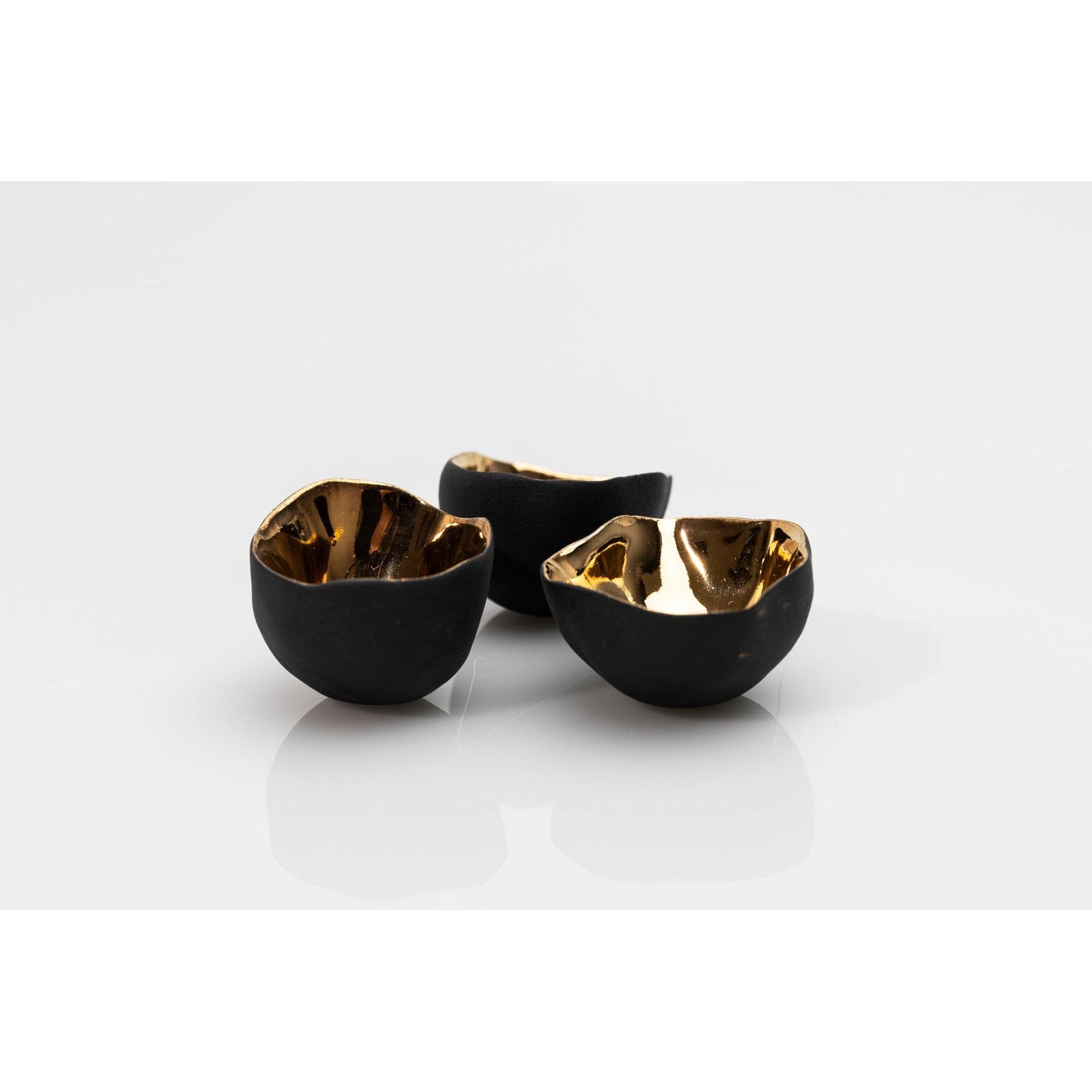 PL04 Trio of Bowls, black porcelain and gold lustre by Penny Little. Available at Padstow Gallery, Cornwall