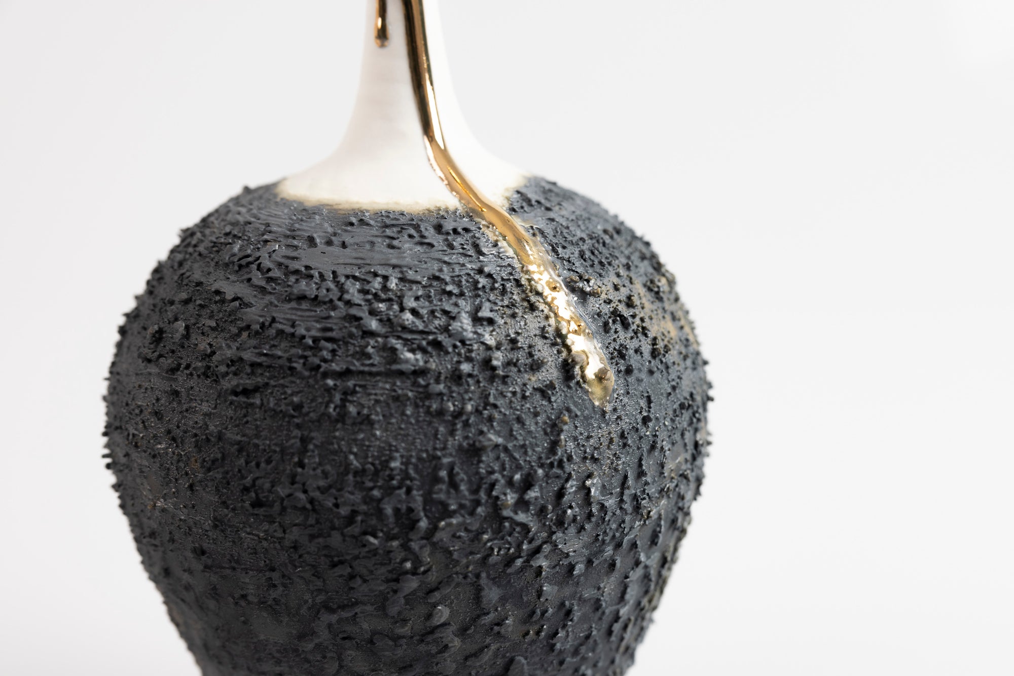Textured long necked vase with gold lustre, by Alex McCarthy, available at Padstow Gallery, Cornwall