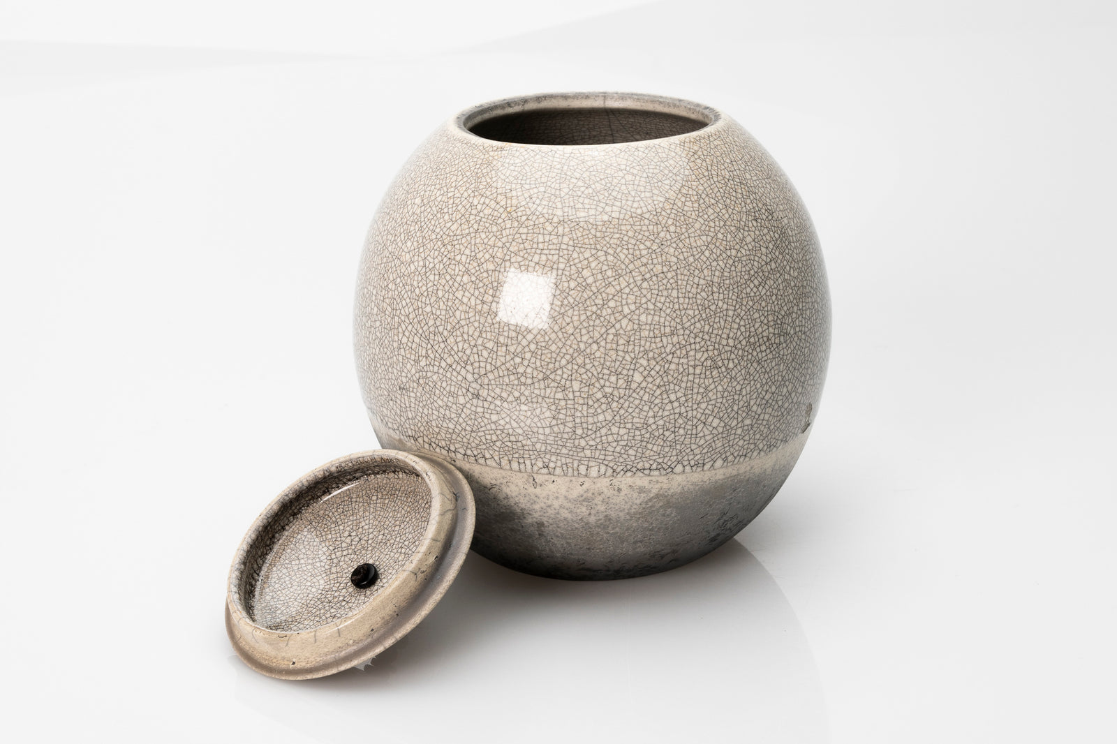 Raku Luna Sphere pot by Kate Schuricht ceramics, available at Padstow Gallery Cornwall