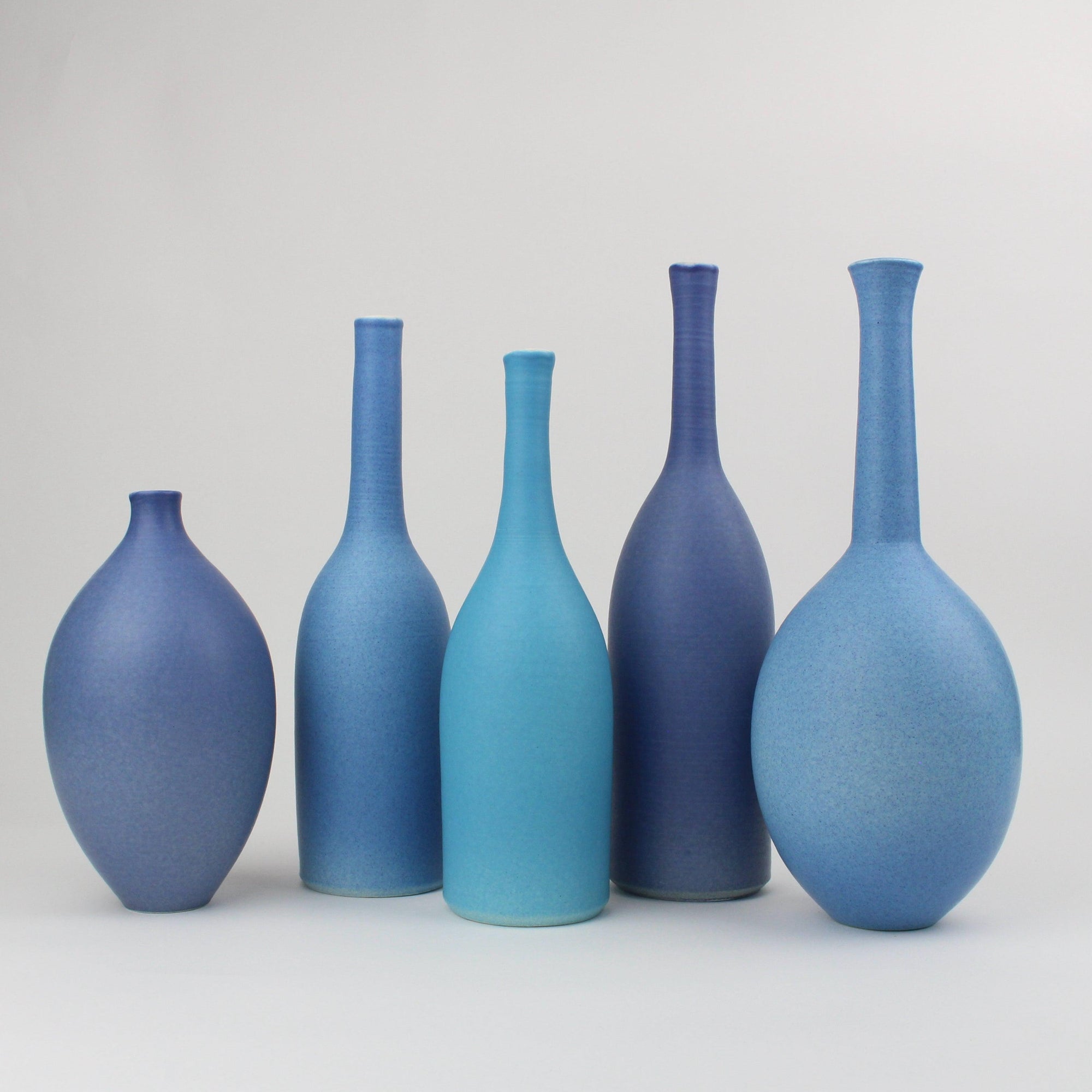 Shades of blue set of bottles by Lucy Burley ceramics, available at Padstow Gallery, Cornwall