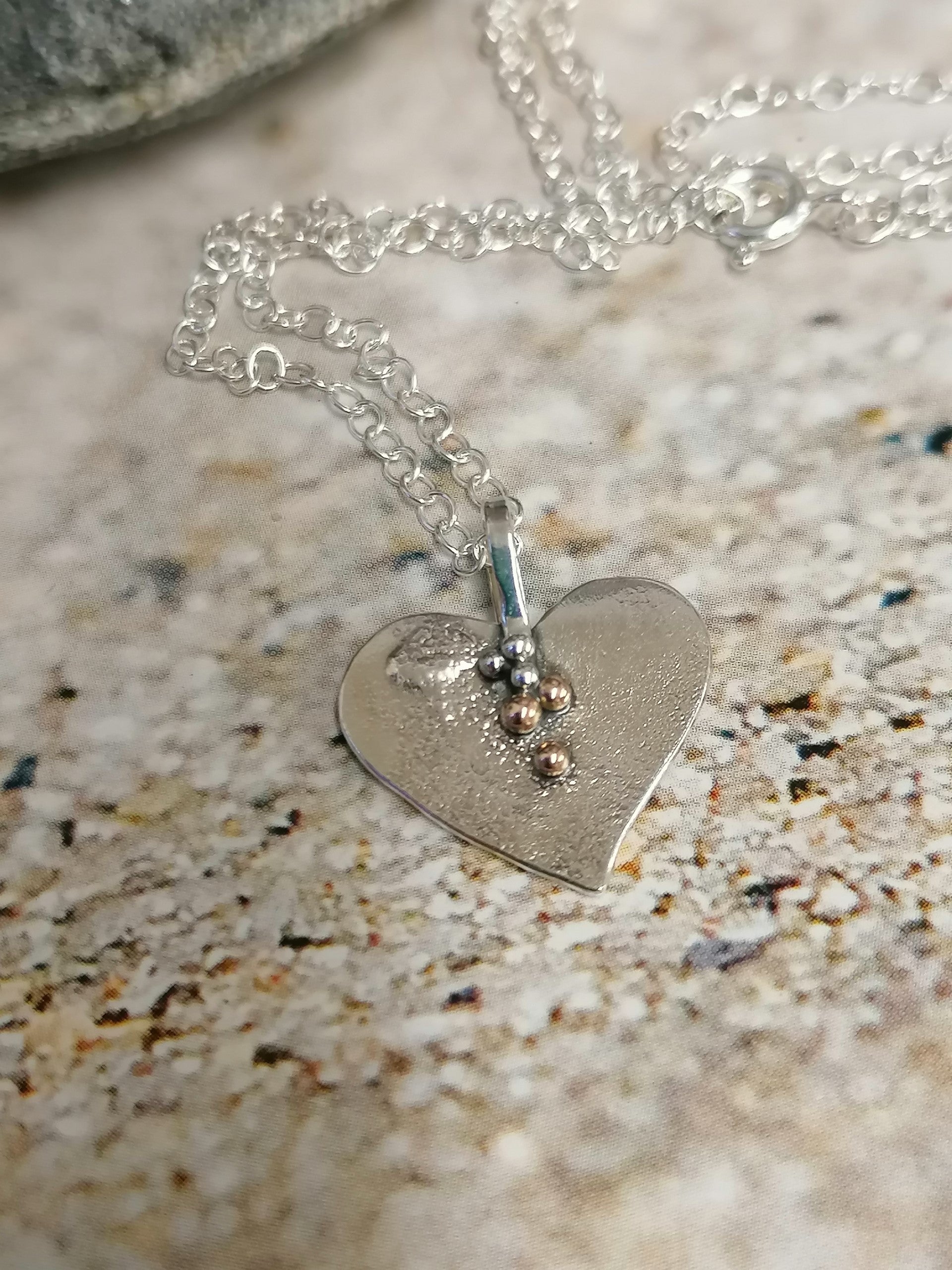 'SA N31  Silver heart necklace with 9ct gold granules' by Sandra Austin jewellery, available at Padstow Gallery, Cornwall